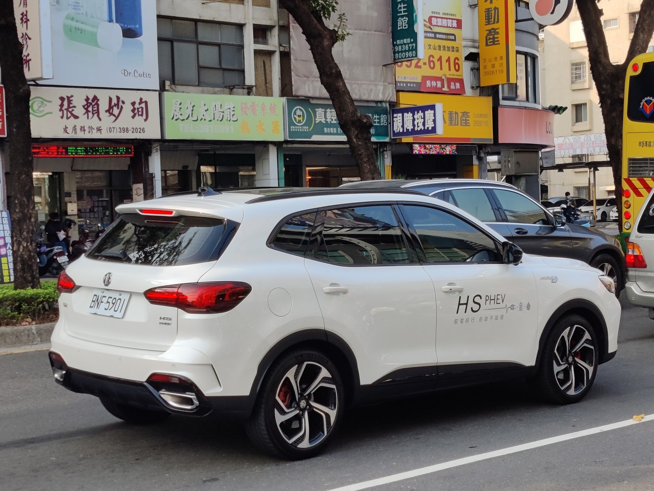 Rear and side profile of a white plug-in hybrid SUV with modern taillights and alloy wheels