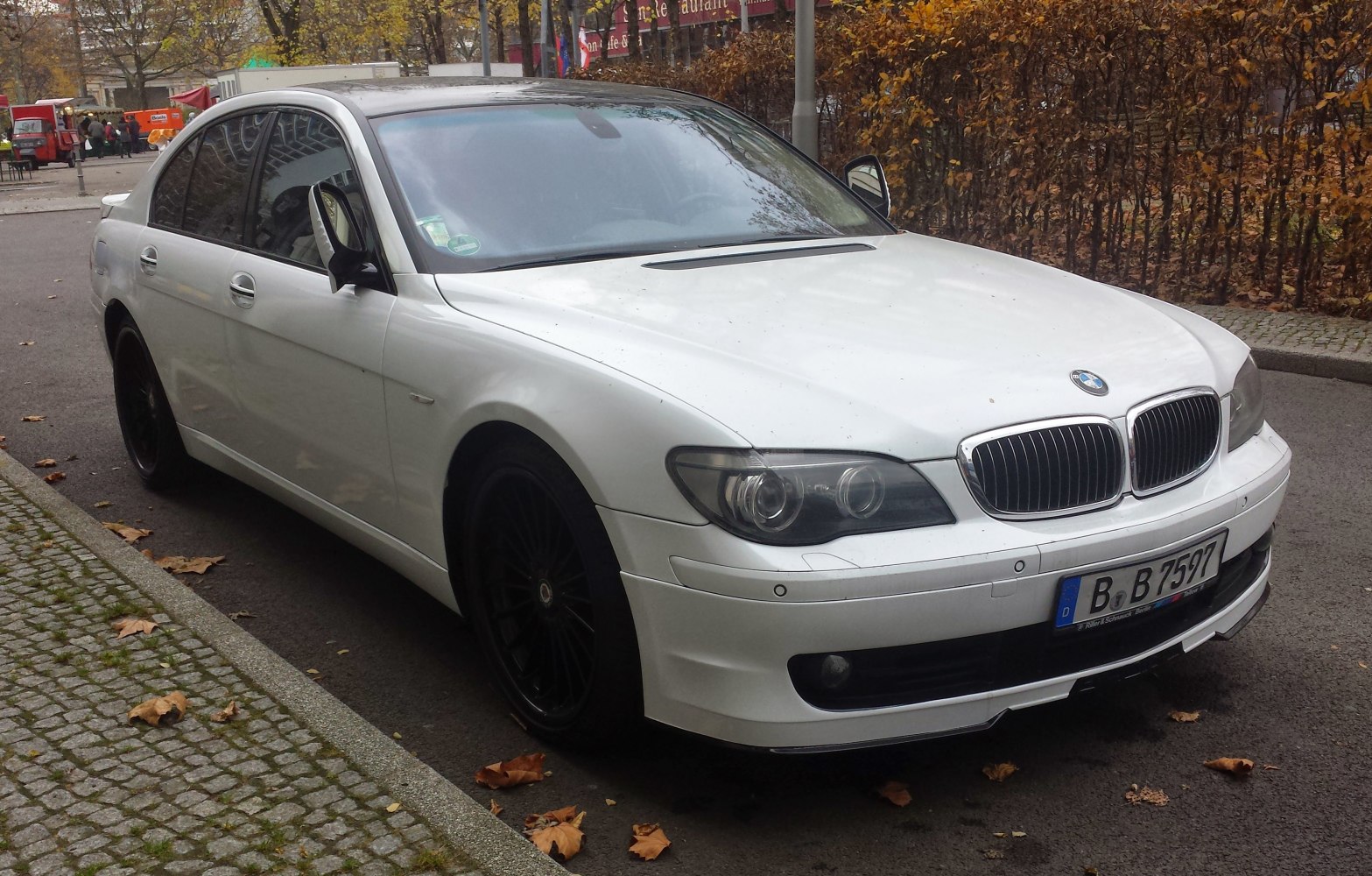 White luxury sedan with kidney grille and black multi-spoke wheels