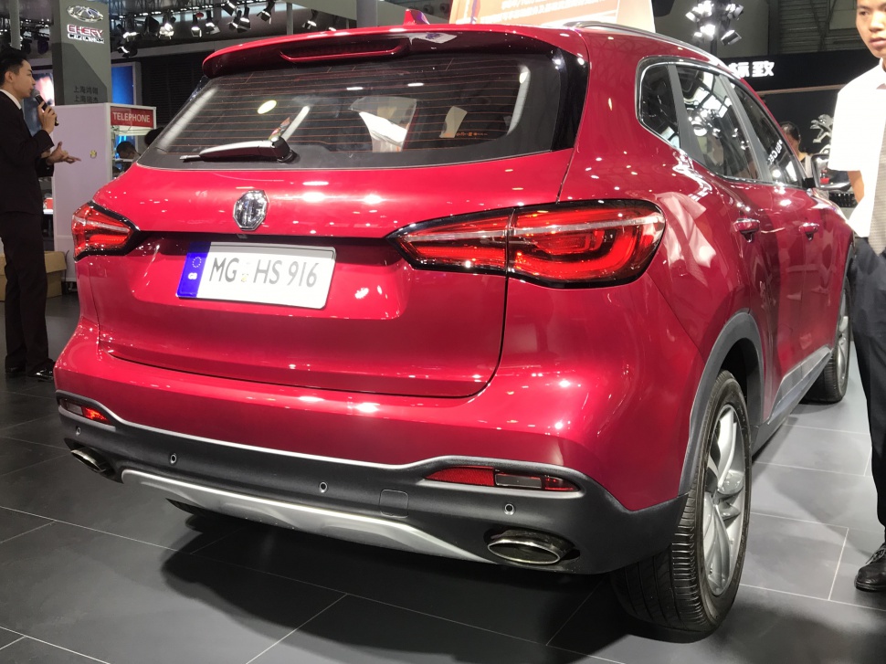 Rear view of a red SUV with LED taillights and dual exhausts