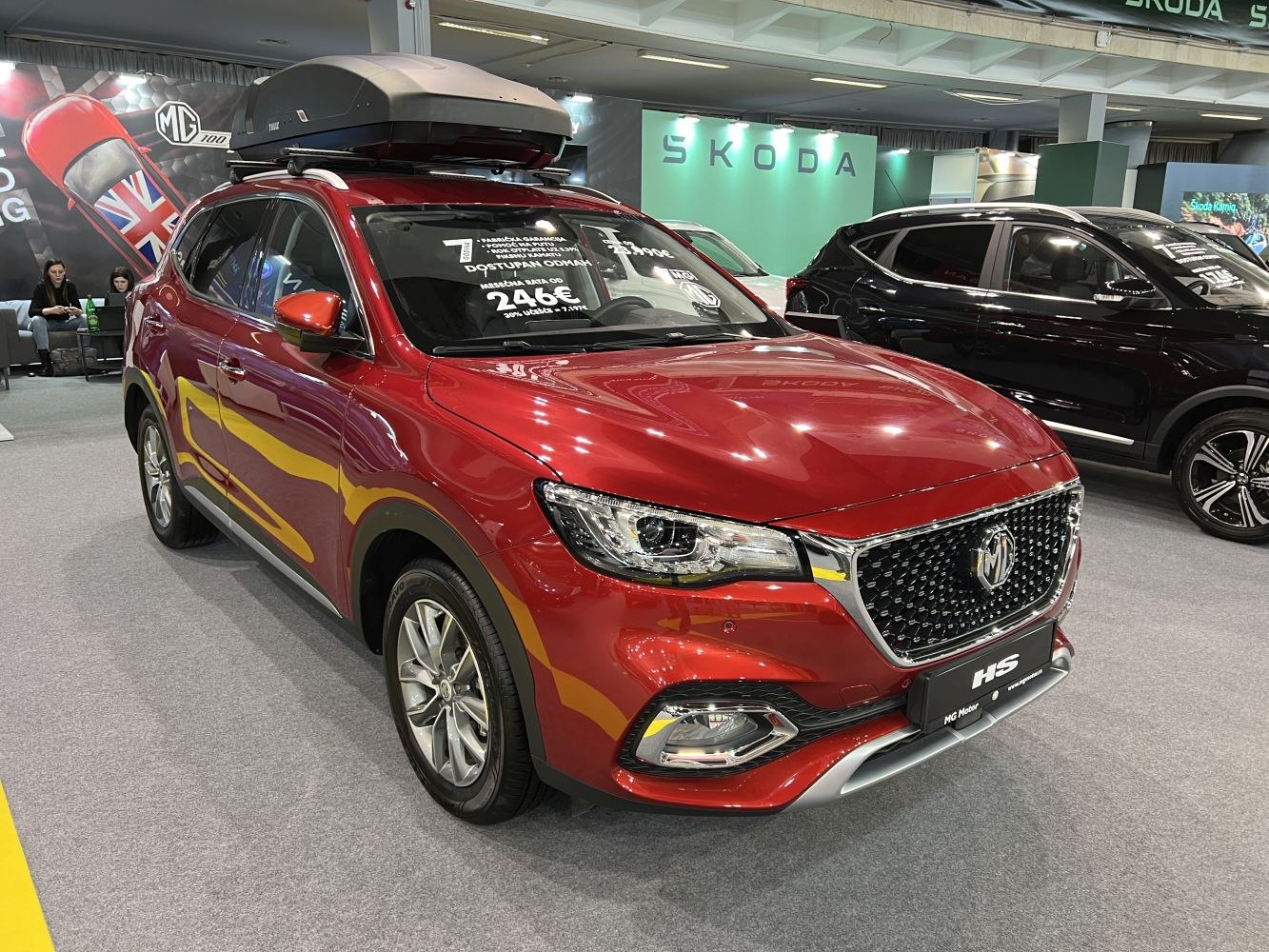 Red SUV with chrome grille and mounted roof box