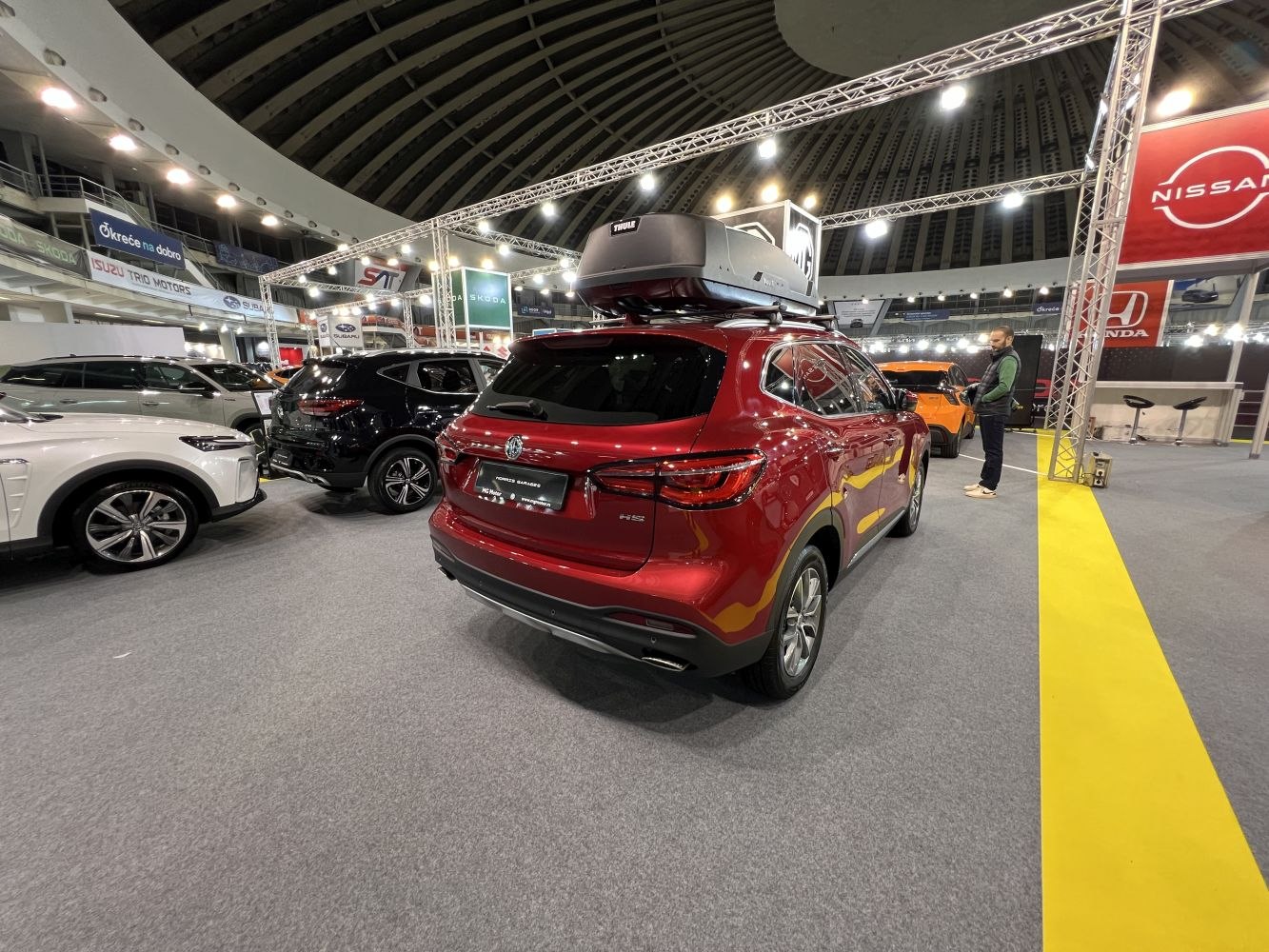 Rear view of an SUV with roof cargo box in exhibition