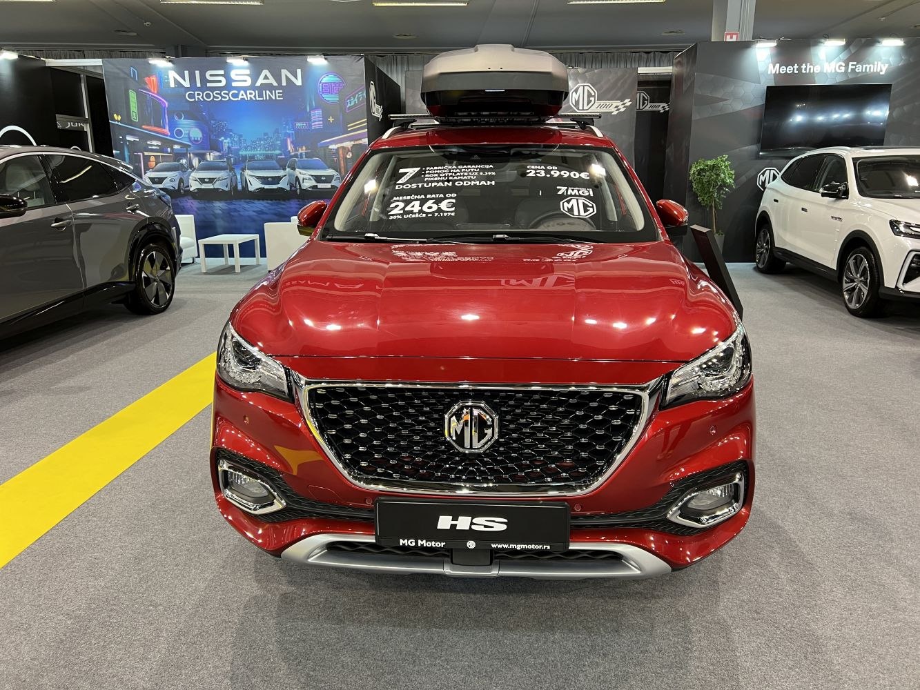Front view of red SUV with roof box and distinctive grille