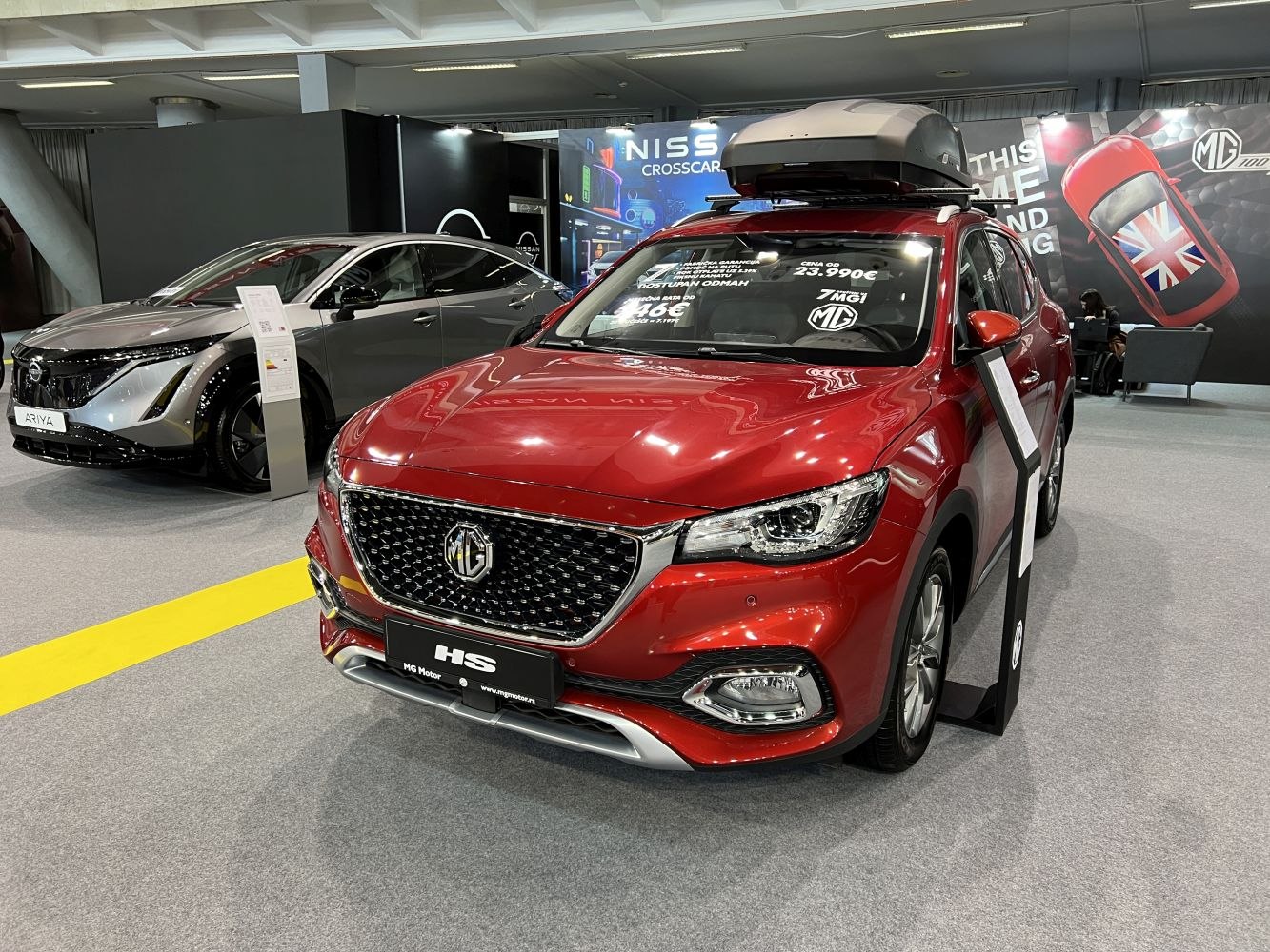 Red SUV with distinctive grille and rooftop cargo box