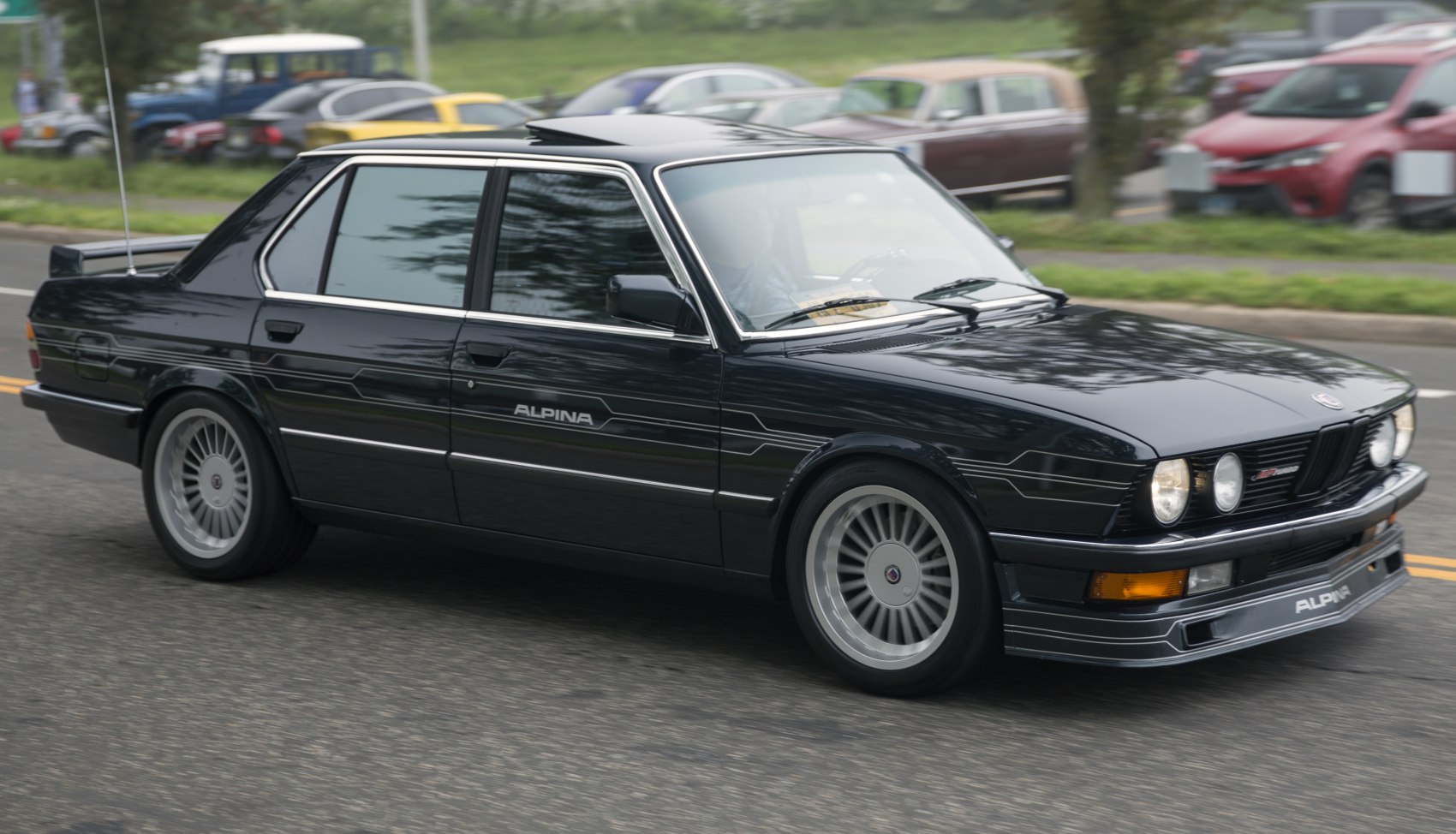 1980s sport sedan with signature decals, multi-spoke alloy wheels, and sunroof