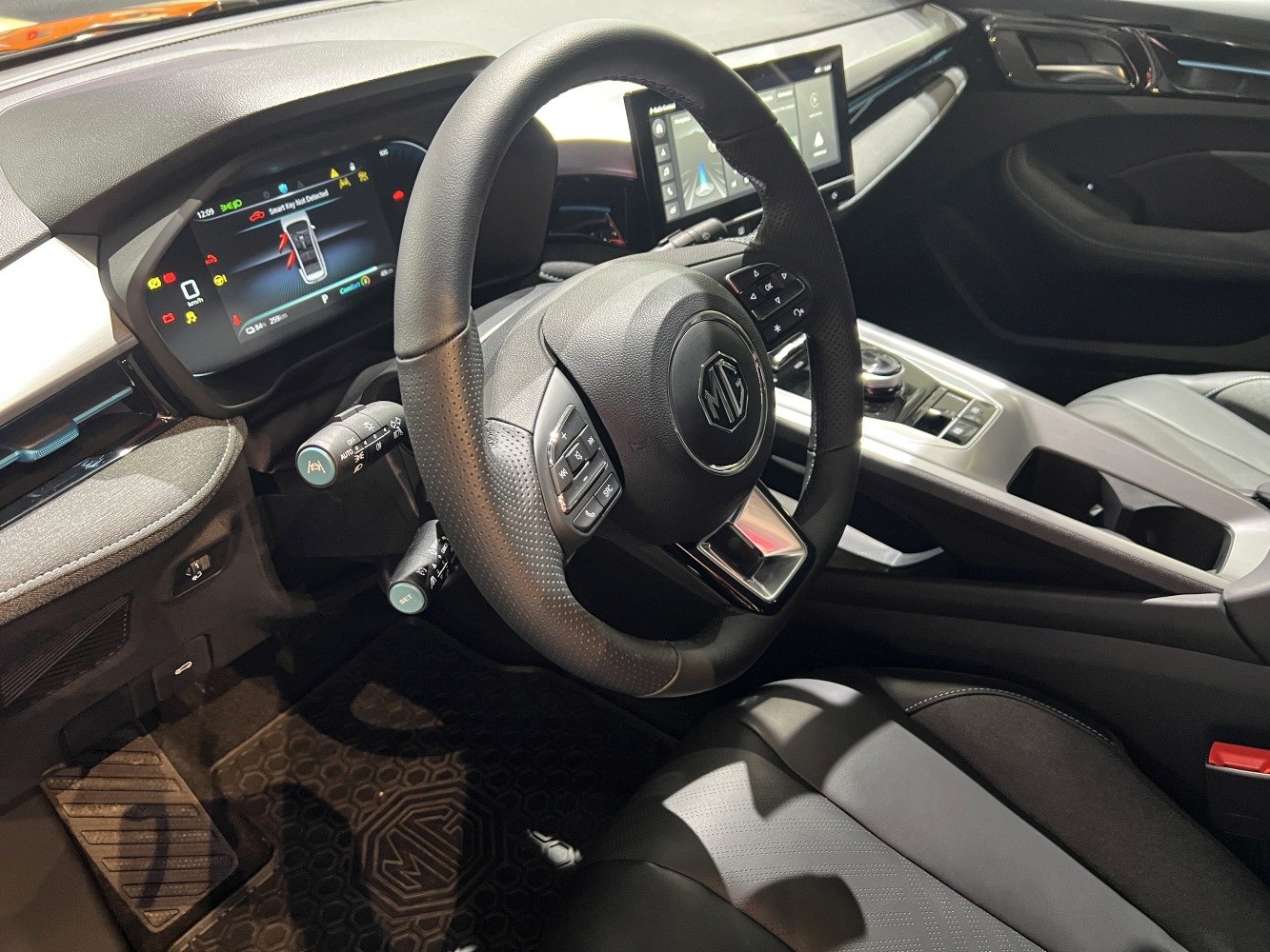 Digital instrument cluster and touchscreen infotainment with multifunction steering wheel.