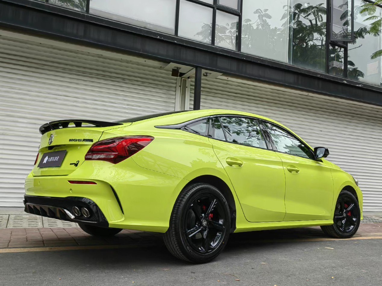 Sporty lime green rear view with quad exhaust and black alloy wheels