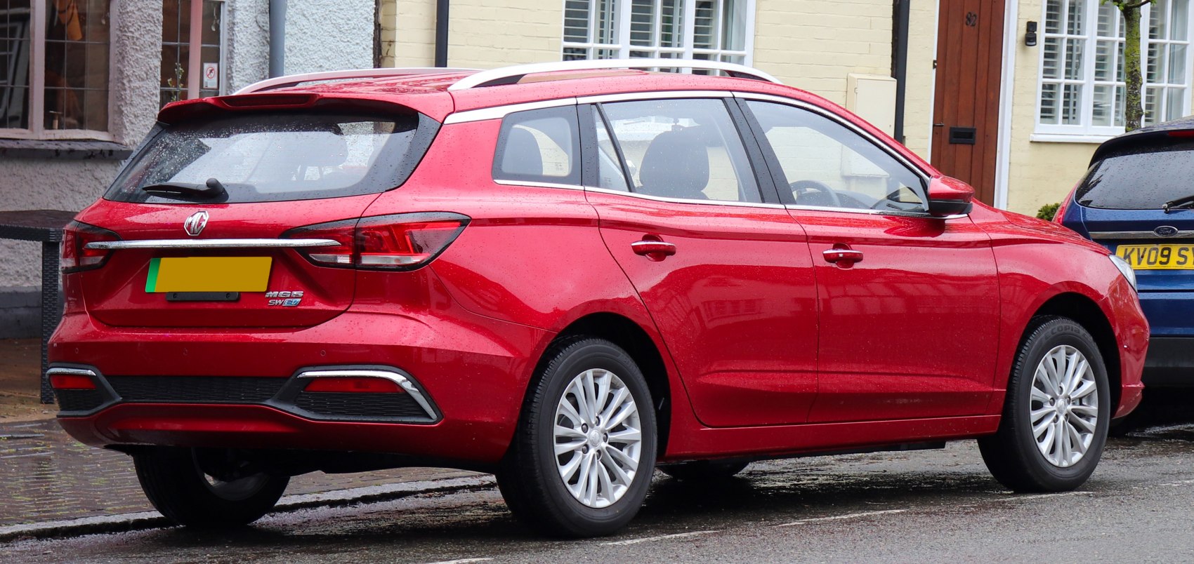 Rear and side view of an electric station wagon with distinct tail lights and alloy wheels