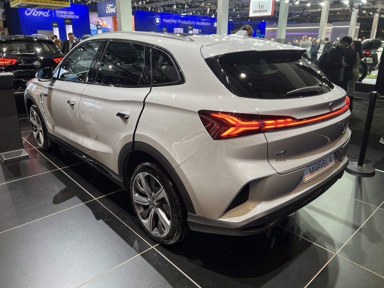 Rear view of a sleek SUV with LED tail light bar and streamlined design.