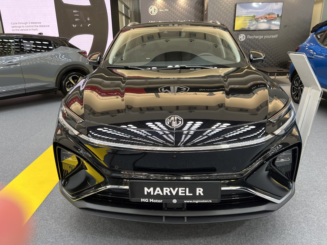 Front view of an electric crossover with LED headlights and sleek grille.