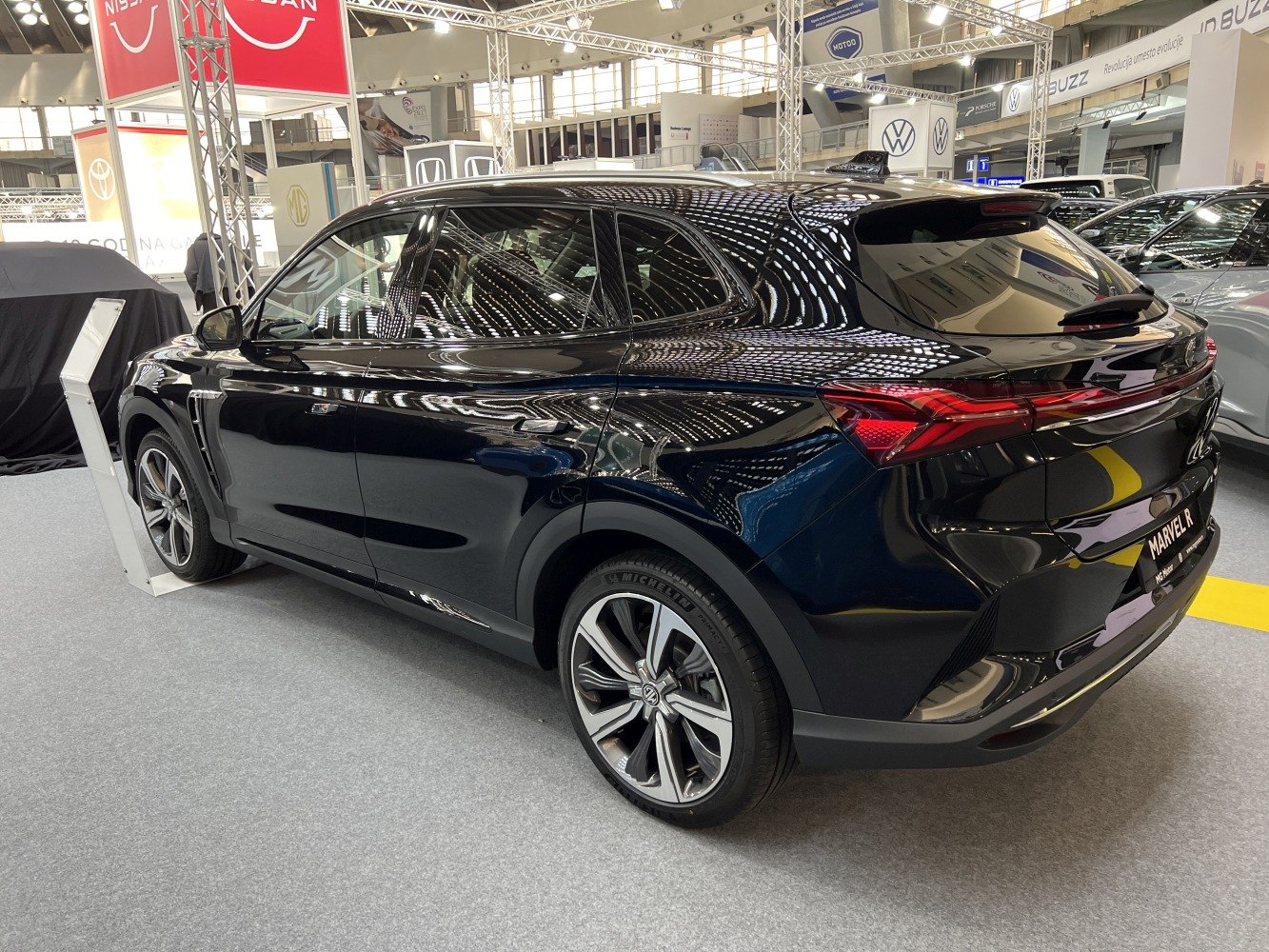 Rear side profile of sleek black electric SUV with alloy wheels