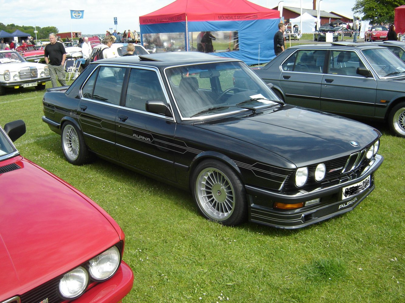 Midsize sedan with Alpina body kit and multi-spoke alloy wheels.