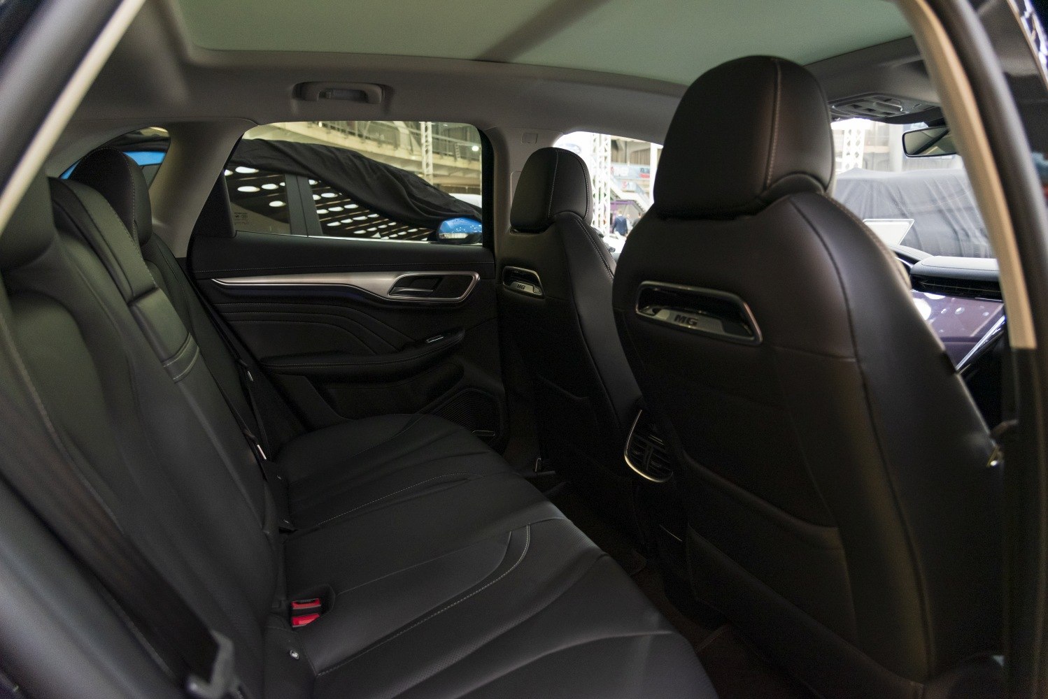 Spacious rear cabin with leather seats and sleek door panel design