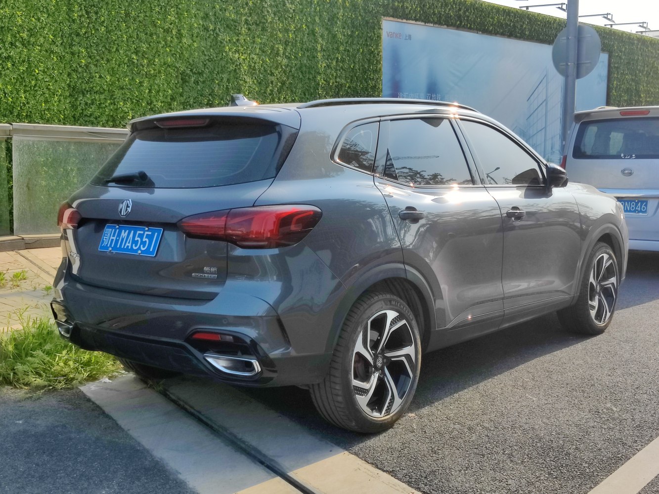 Rear side view of modern SUV with distinctive taillights and alloy wheels.