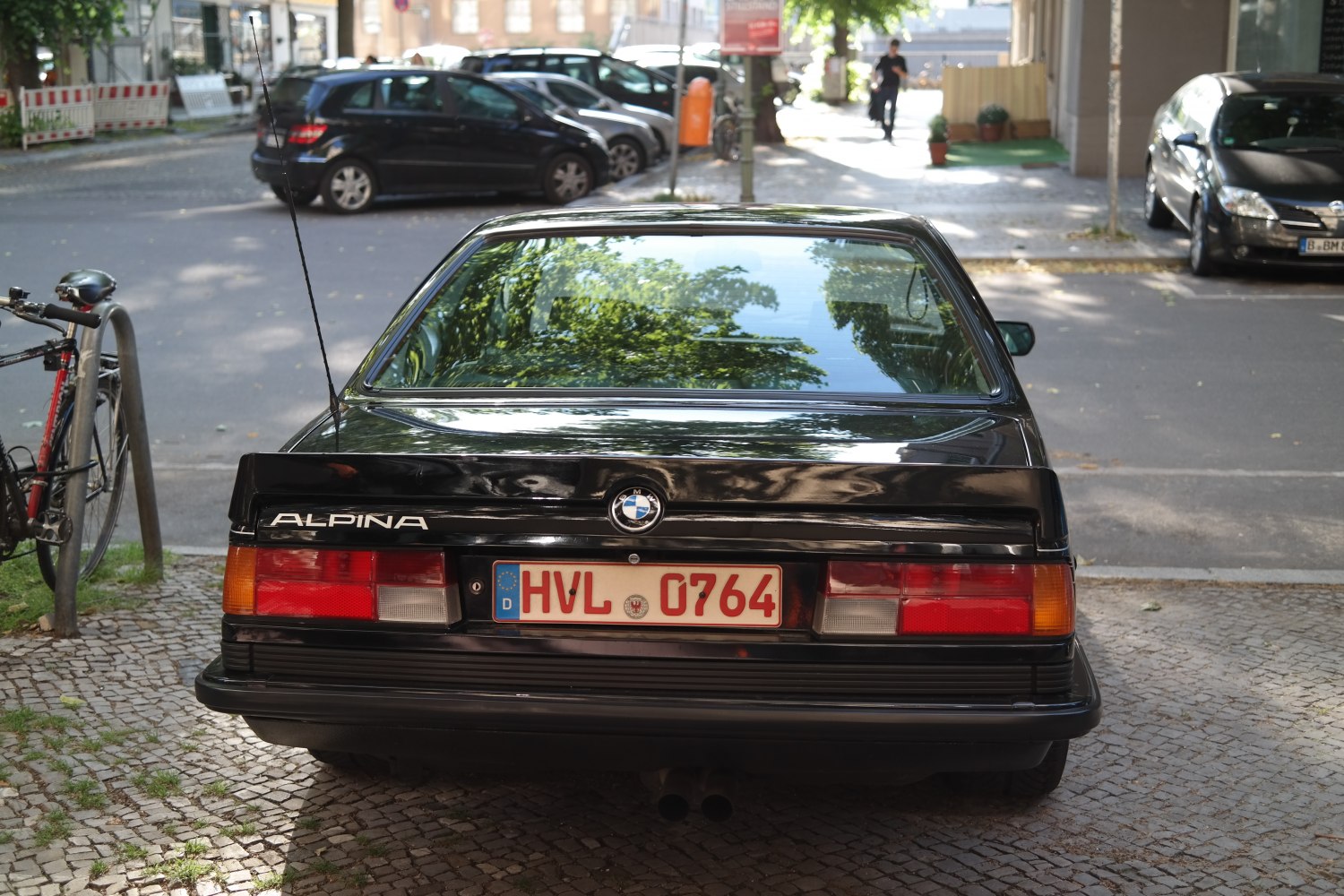 Rear view with distinct taillights and spoiler on classic coupe