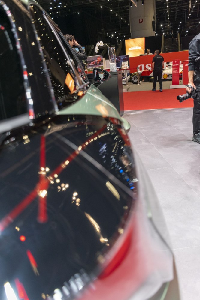 Close-up of side mirror and window reflections in a modern electric vehicle.
