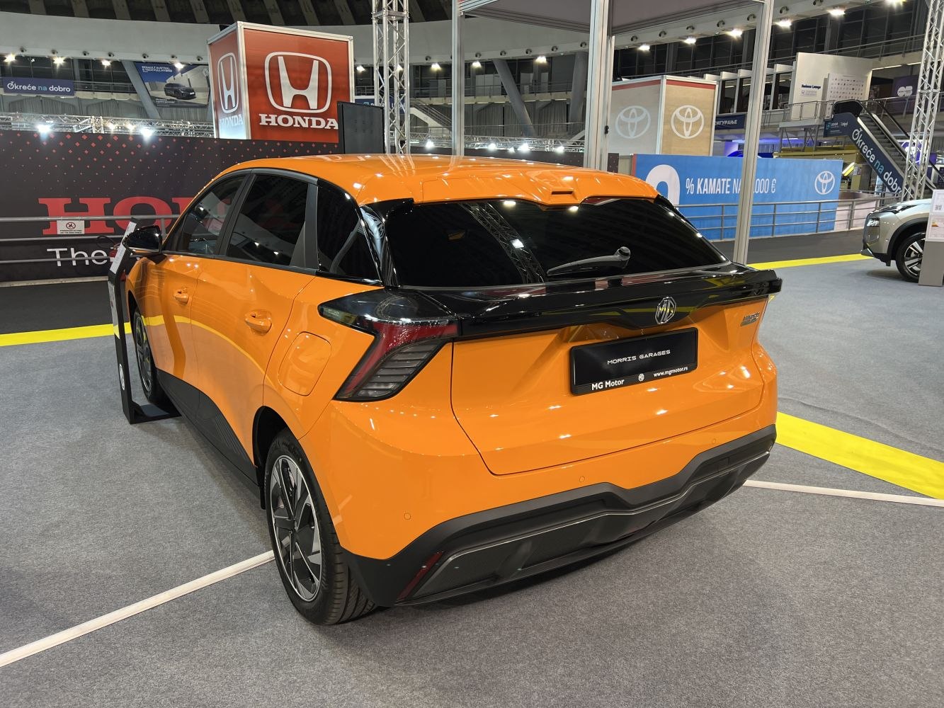 Electric hatchback rear view with distinctive taillights and sporty design.