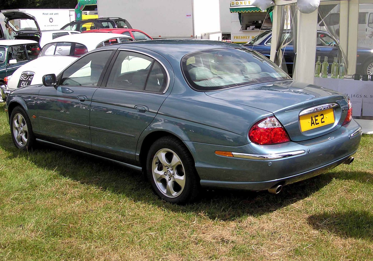 Rear and side view of classic luxury sedan with distinct taillights and chrome accents