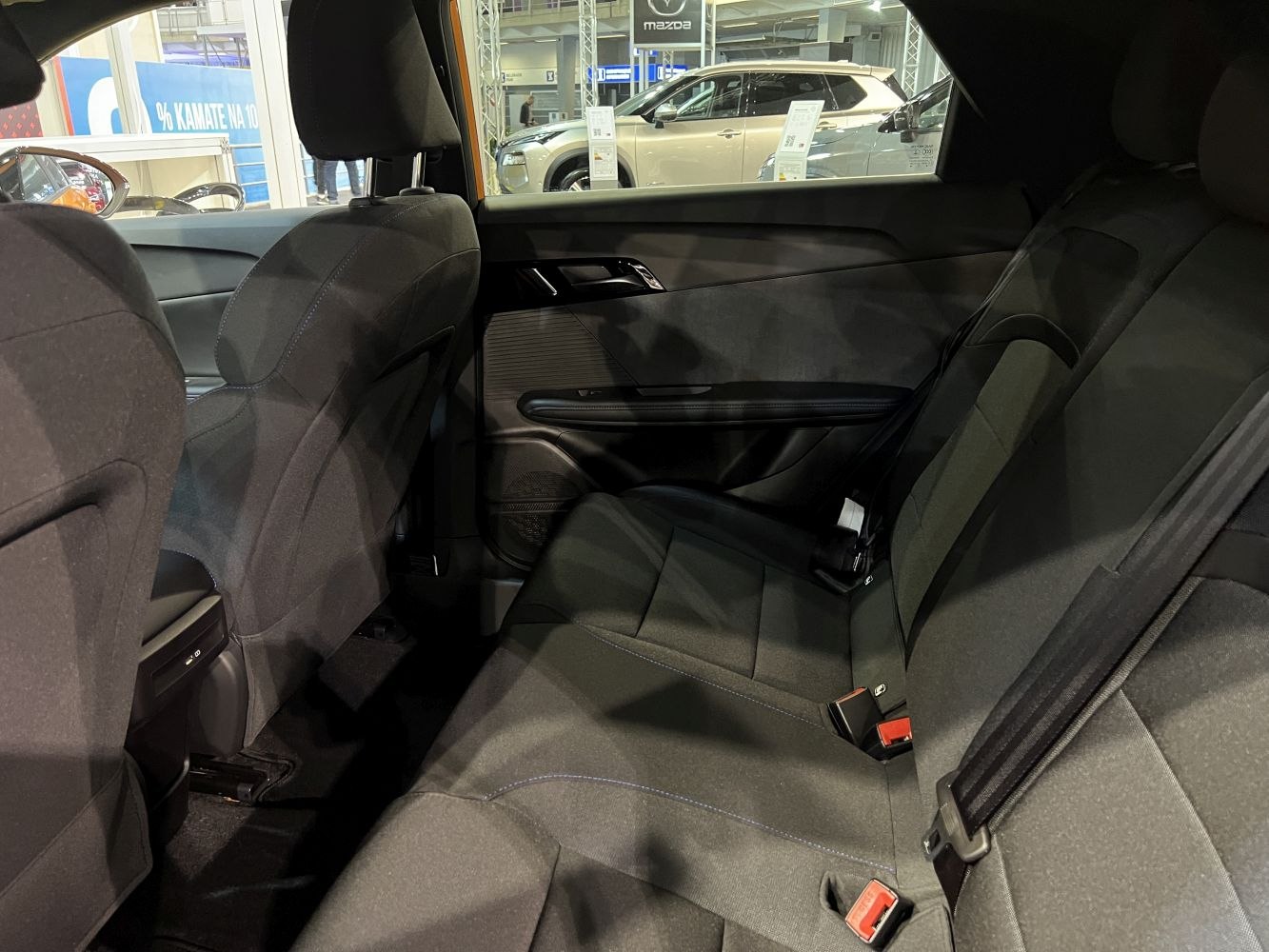 Rear seat interior with fabric upholstery and seat belts