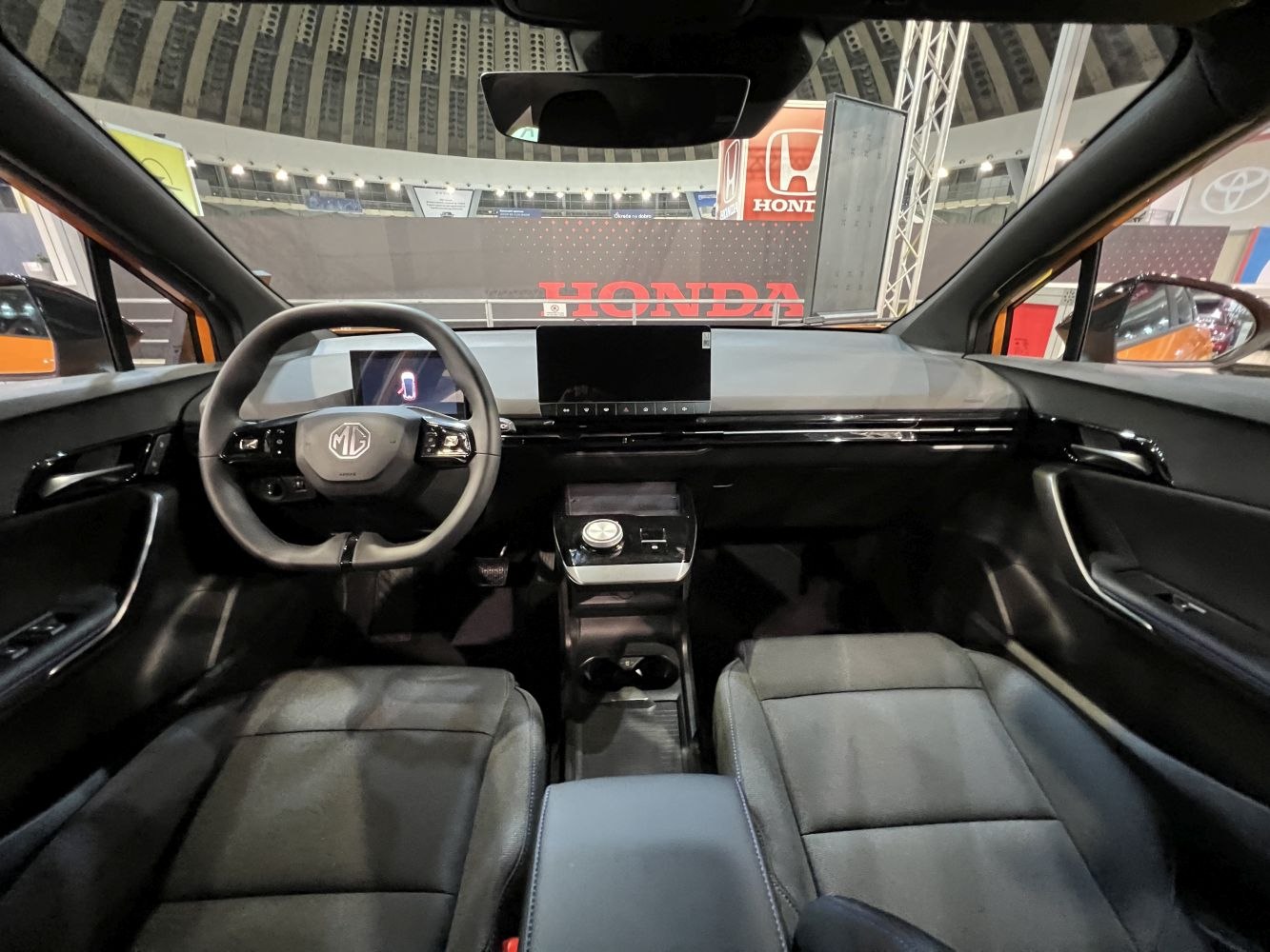 Modern electric vehicle interior with digital cluster and touchscreen