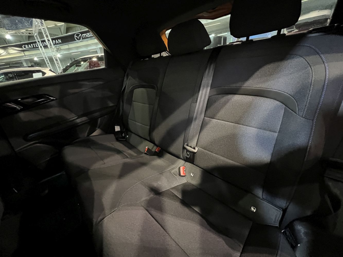 Fabric rear seat upholstery with seatbelt and headrests