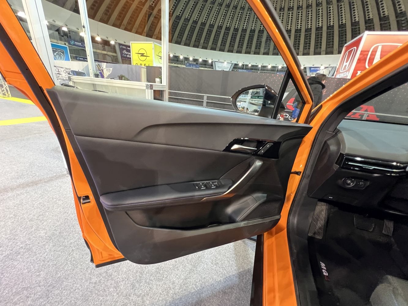 Modern car interior focusing on driver side door panel and controls