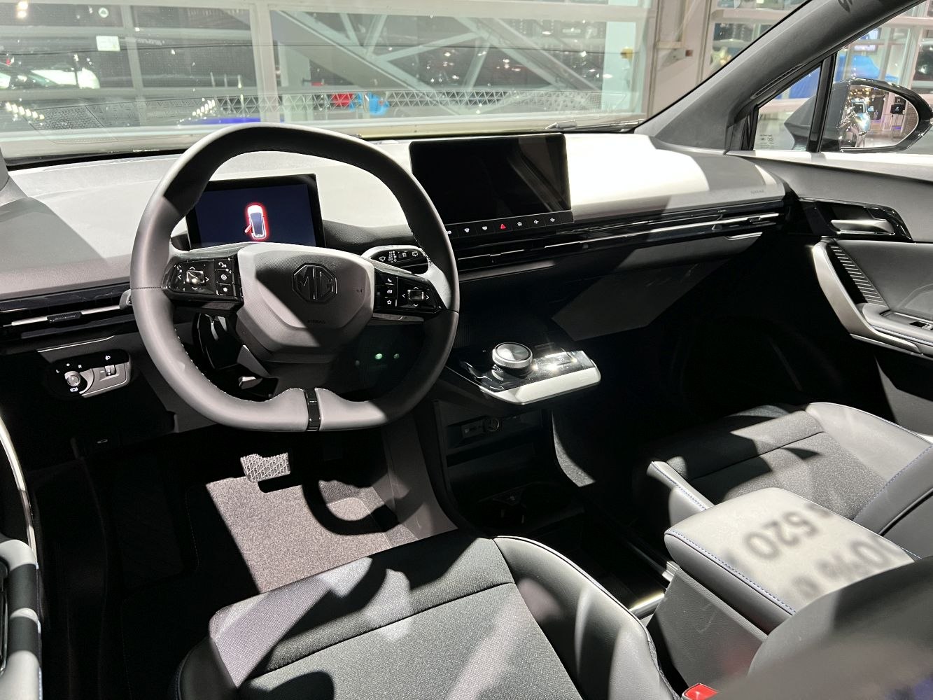 Modern car dashboard with digital displays and multifunction steering wheel