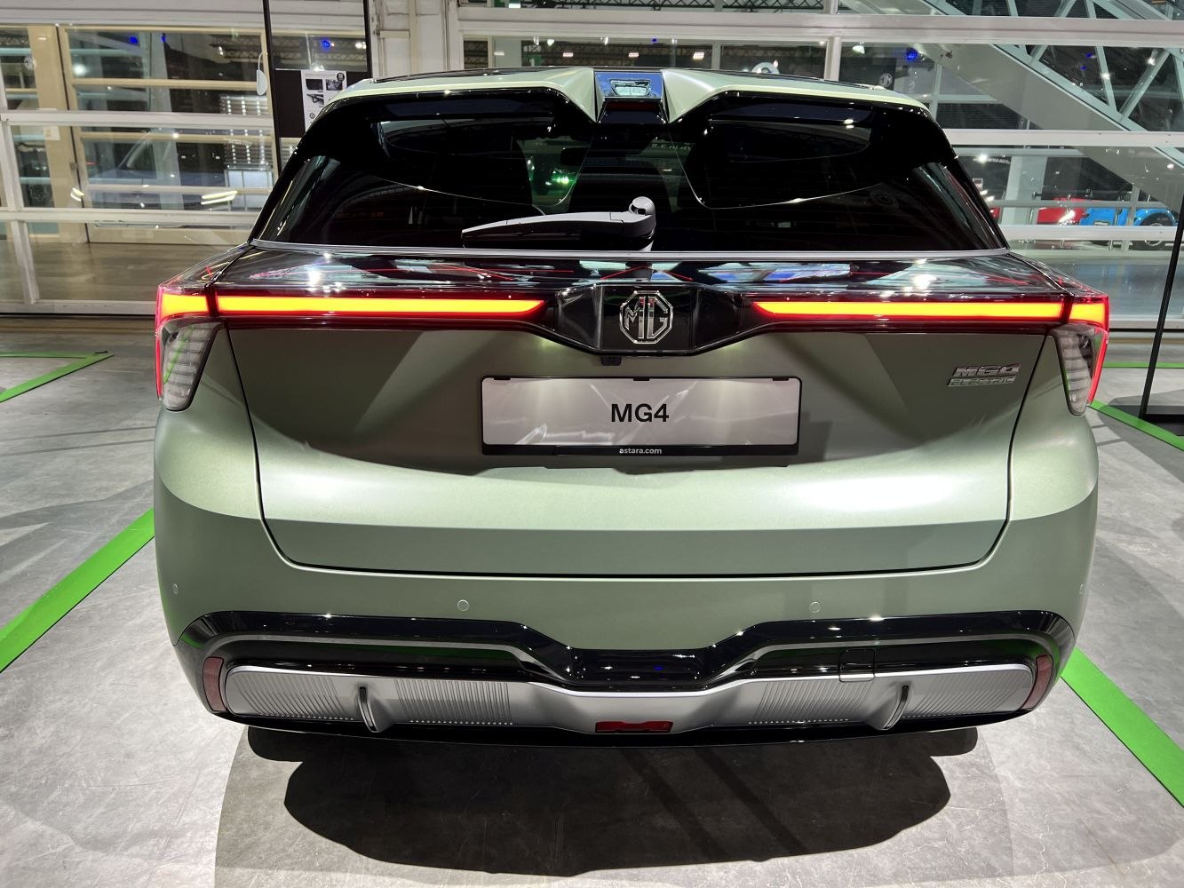 Rear view with continuous LED strip tail lights and sleek hatchback design