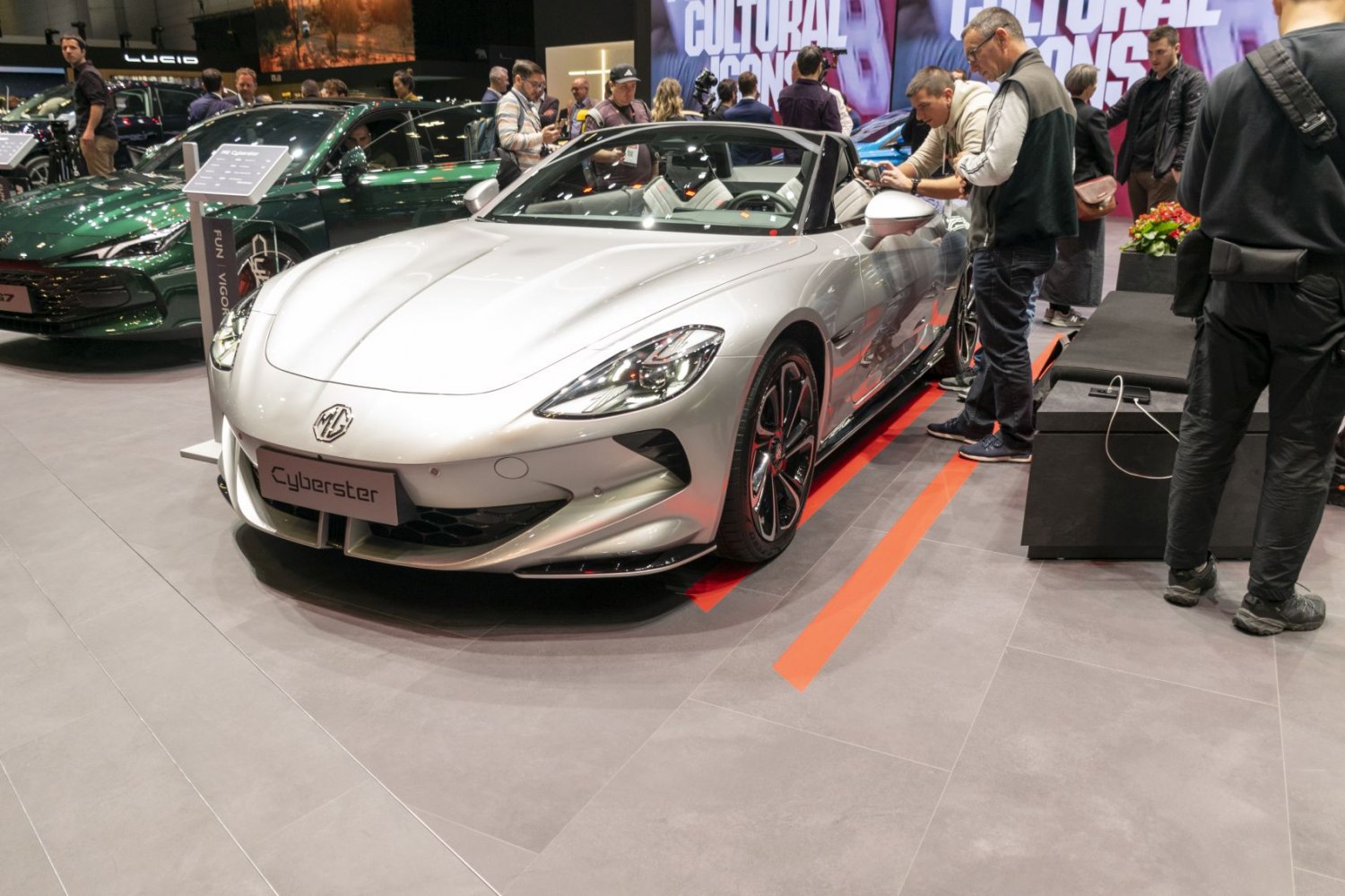 Silver electric convertible roadster with sleek headlights and sporty wheels