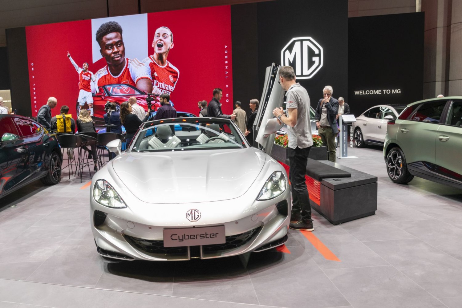 Front view of a sleek electric convertible roadster with detailed headlights and aerodynamic design.