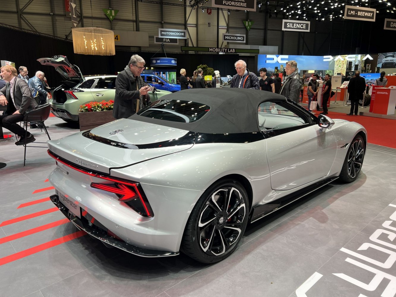 Silver convertible with black soft top and angular LED taillights
