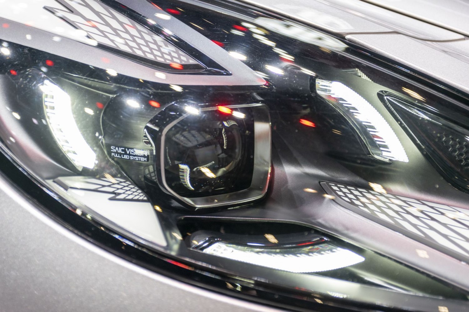 Close-up of advanced full LED projector headlight with patterns and LED strips