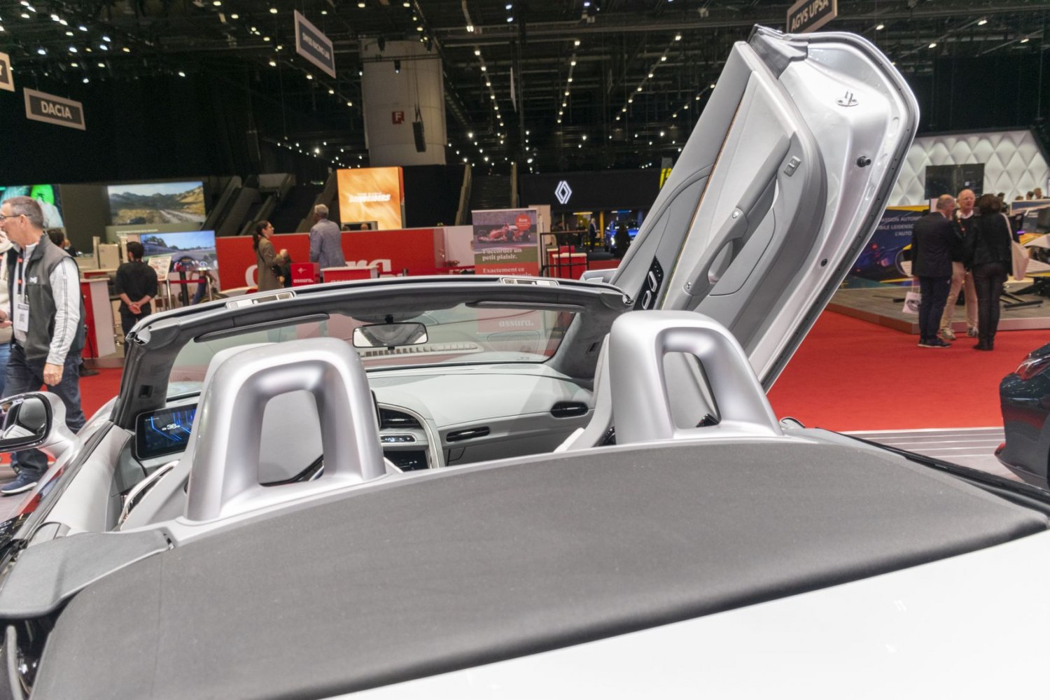 Convertible door open with two-seater interior and digital dashboard