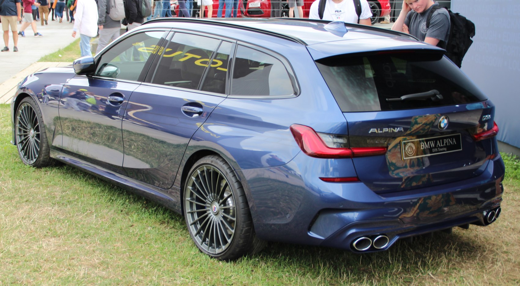 Blue performance touring wagon with quad exhaust and multi-spoke wheels