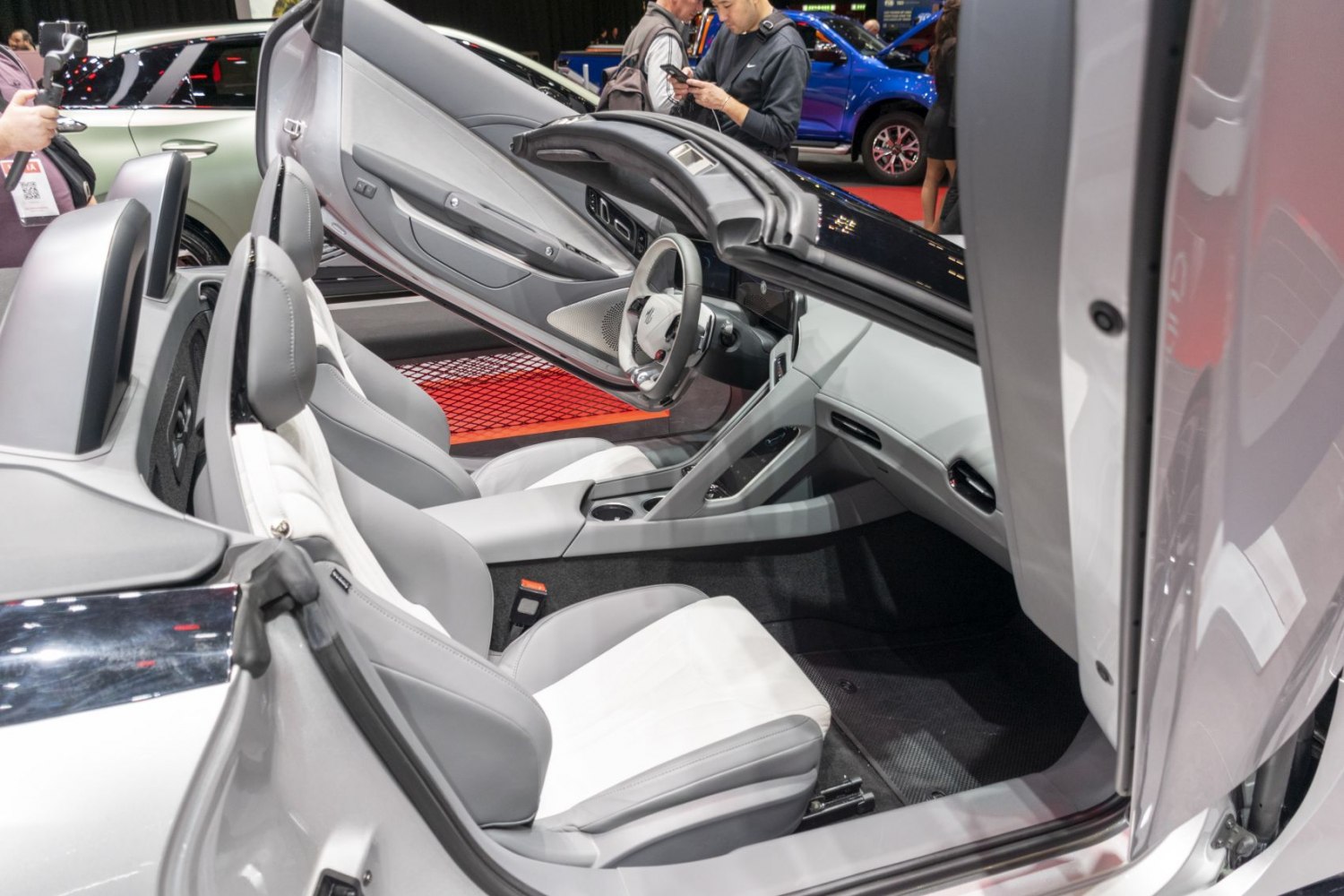 Two-seater minimalist interior with open butterfly doors