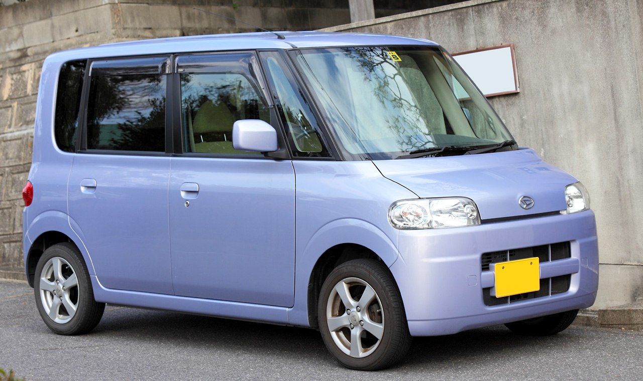 Compact boxy kei car front side with rectangular headlights and five-spoke wheels