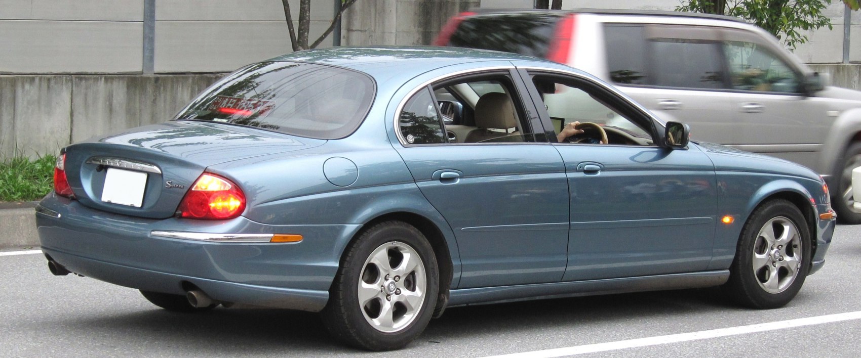 Rear and side view of a sedan with alloy wheels and distinctive tail lights
