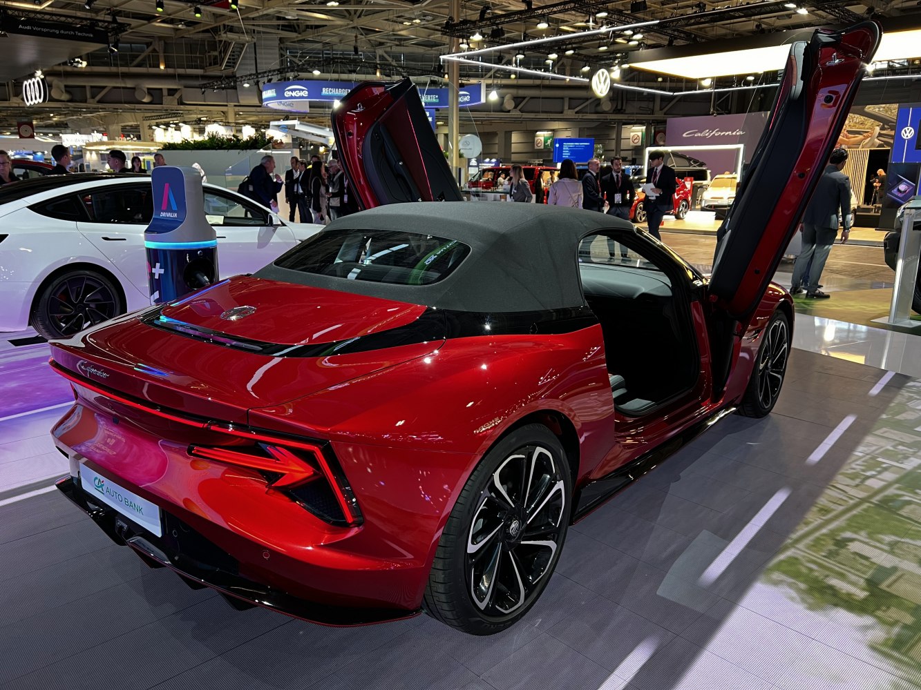 Red electric convertible with soft top and butterfly doors