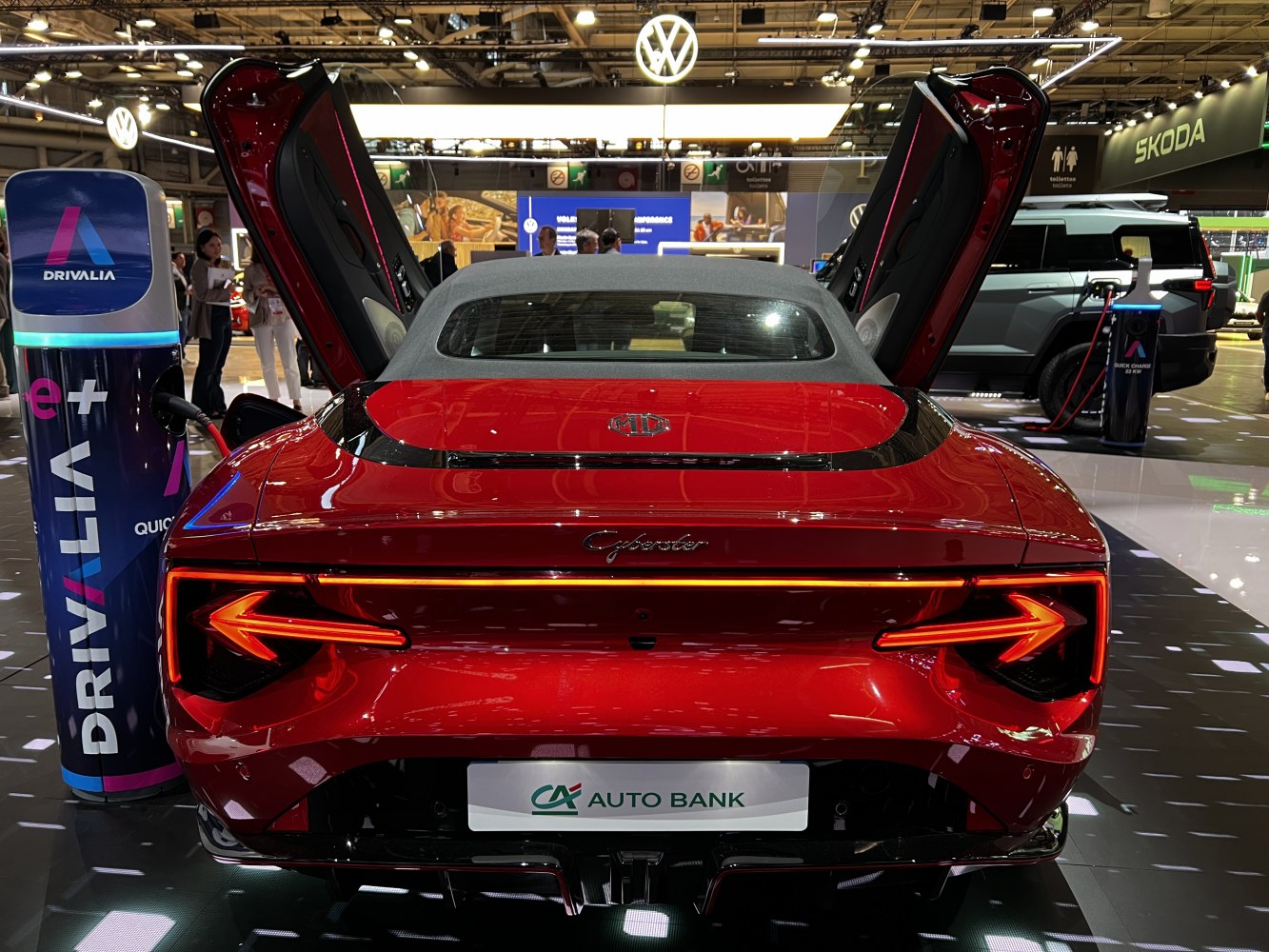 Rear view with butterfly doors open and LED arrow-shaped tail lights.