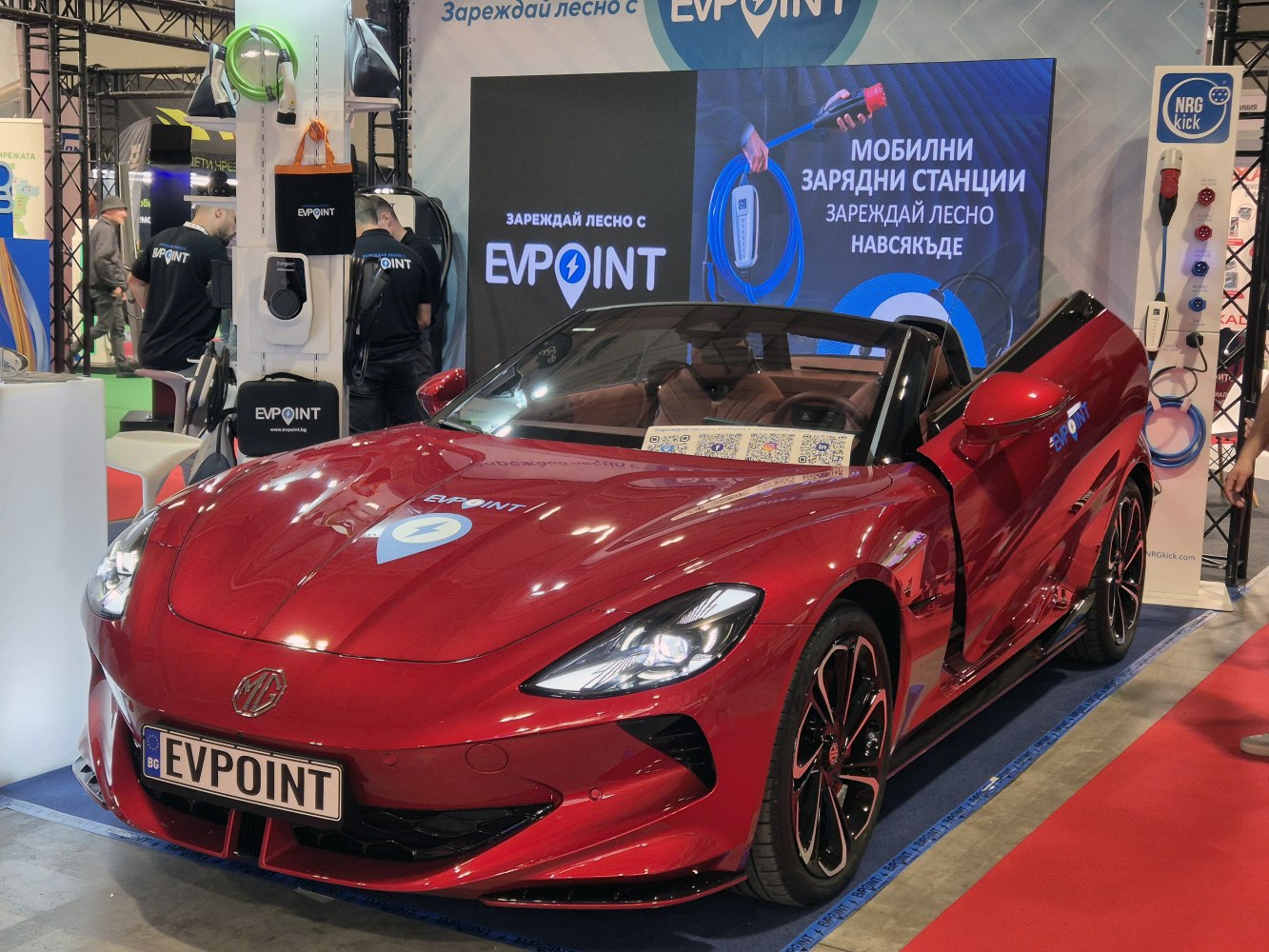 Sleek electric red convertible roadster with modern LED headlights.