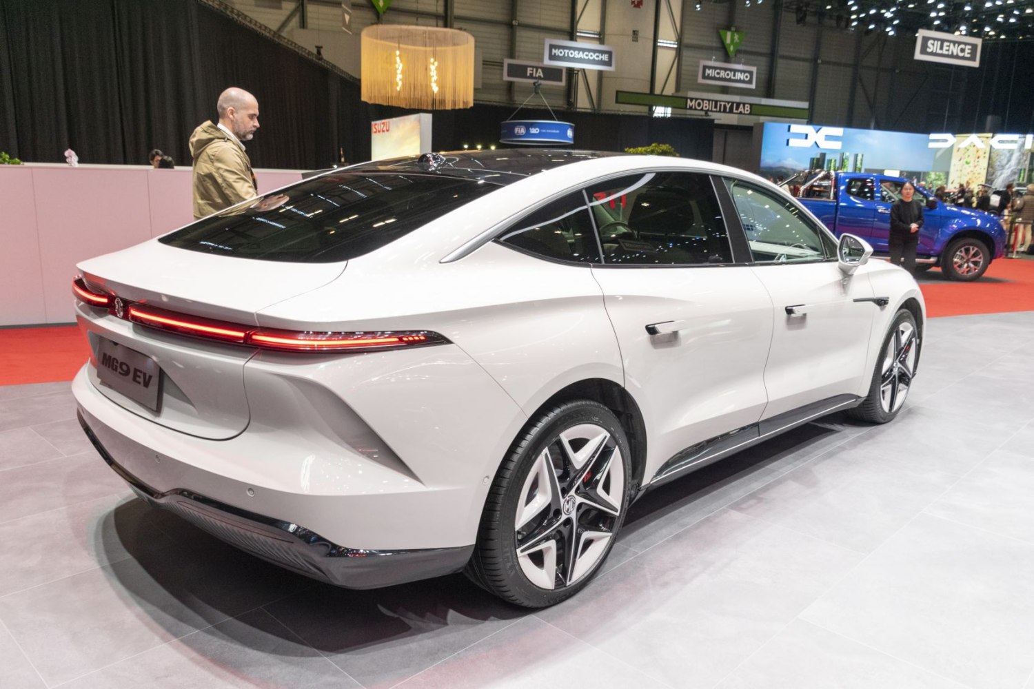 Rear view of electric sedan with LED light bar and aerodynamic shape