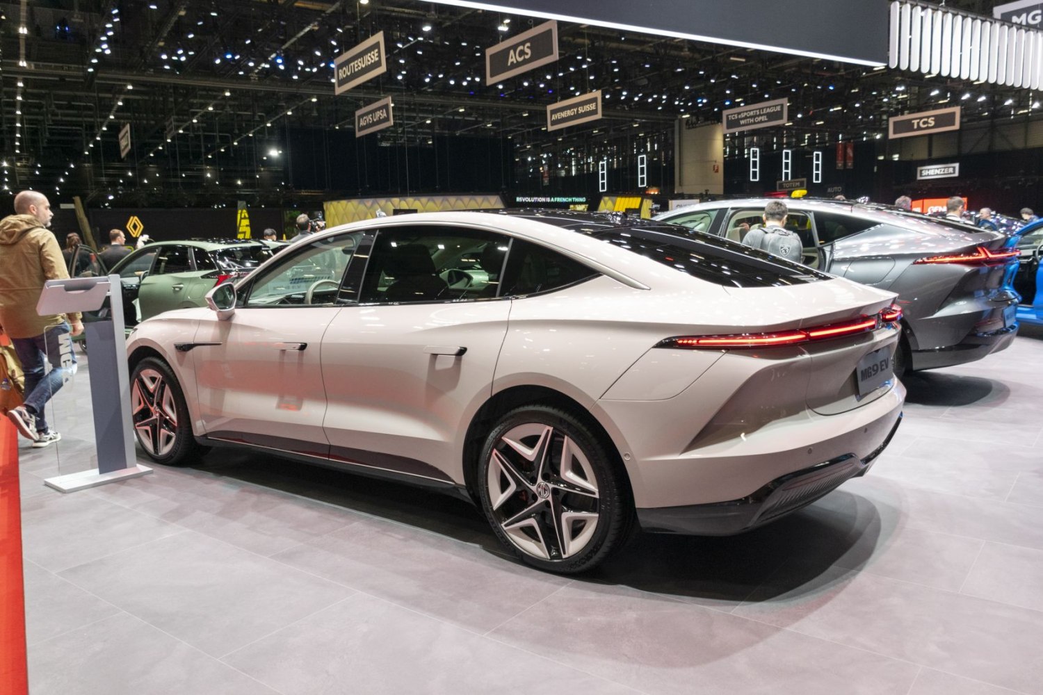 Rear-side view highlighting sleek LED tail lights and aerodynamic electric sedan design