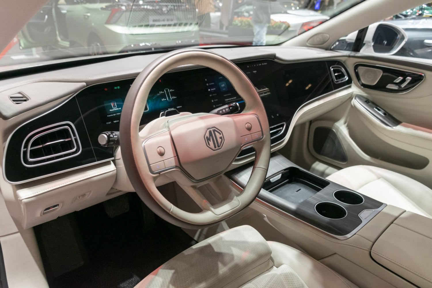 Modern electric vehicle interior with digital instrument cluster and dual touchscreen display