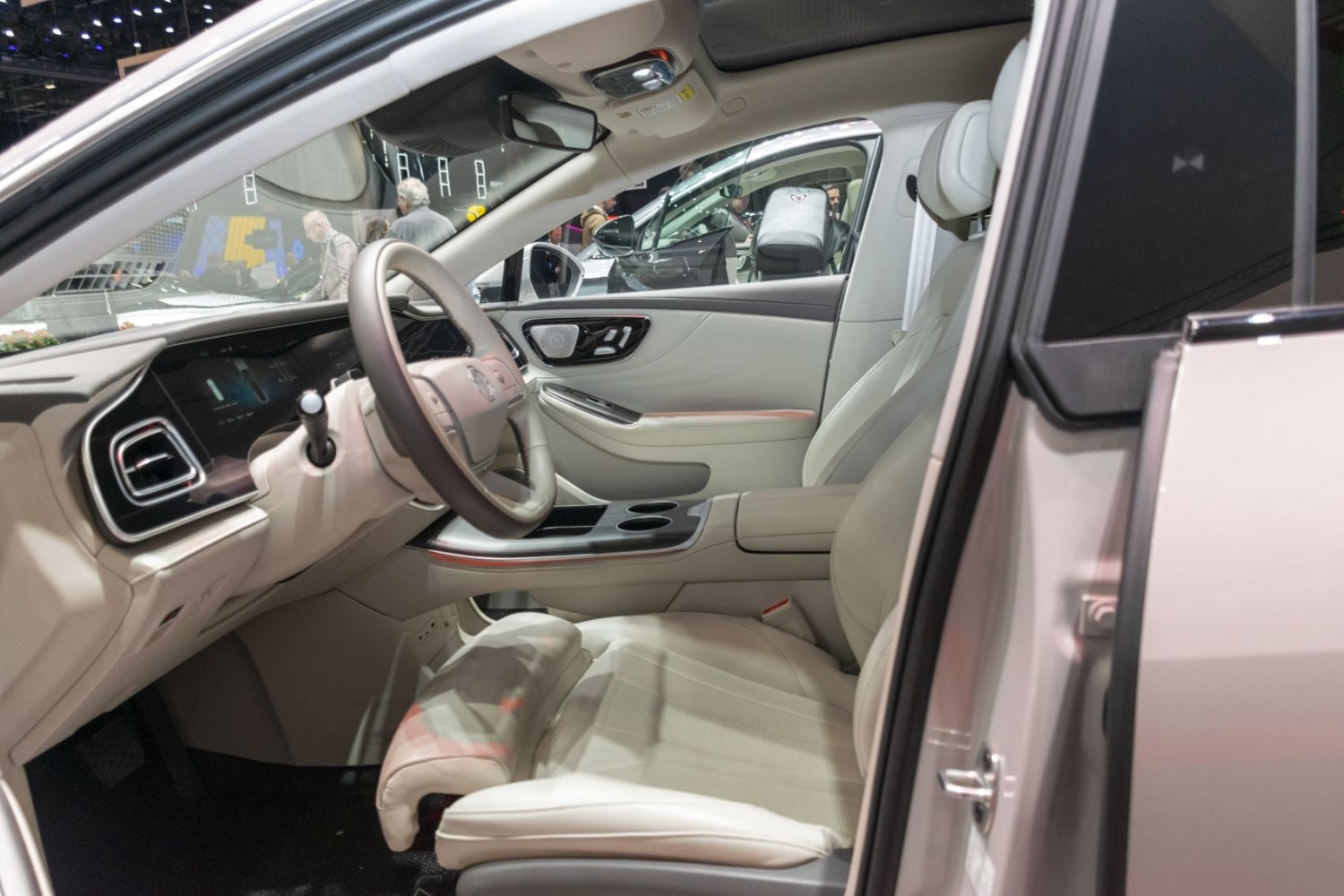 Digital dashboard and plush beige leather seats in modern EV interior