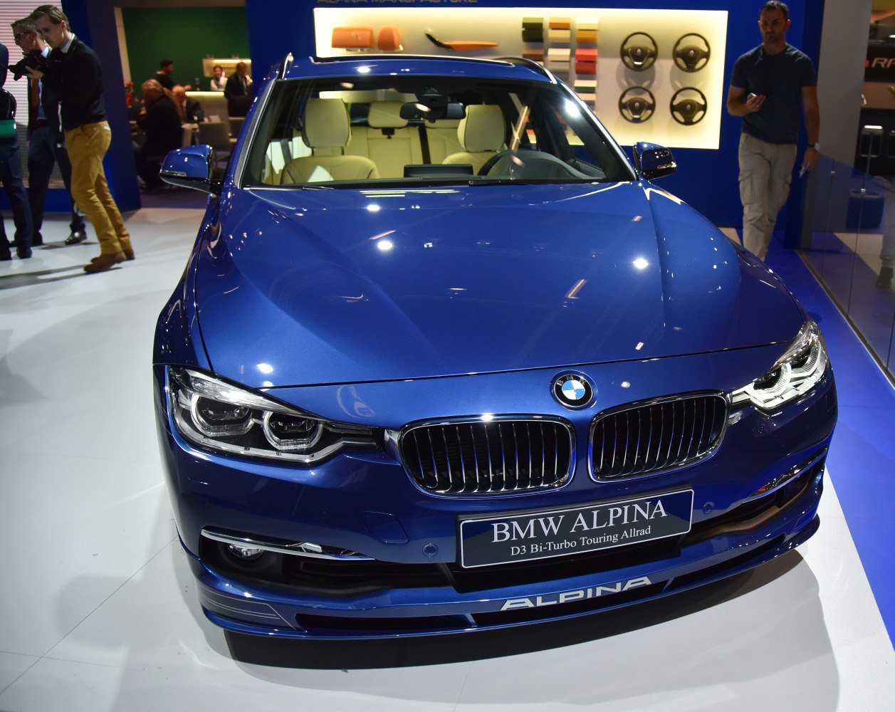 Blue car front with iconic kidney grille and sharp headlights