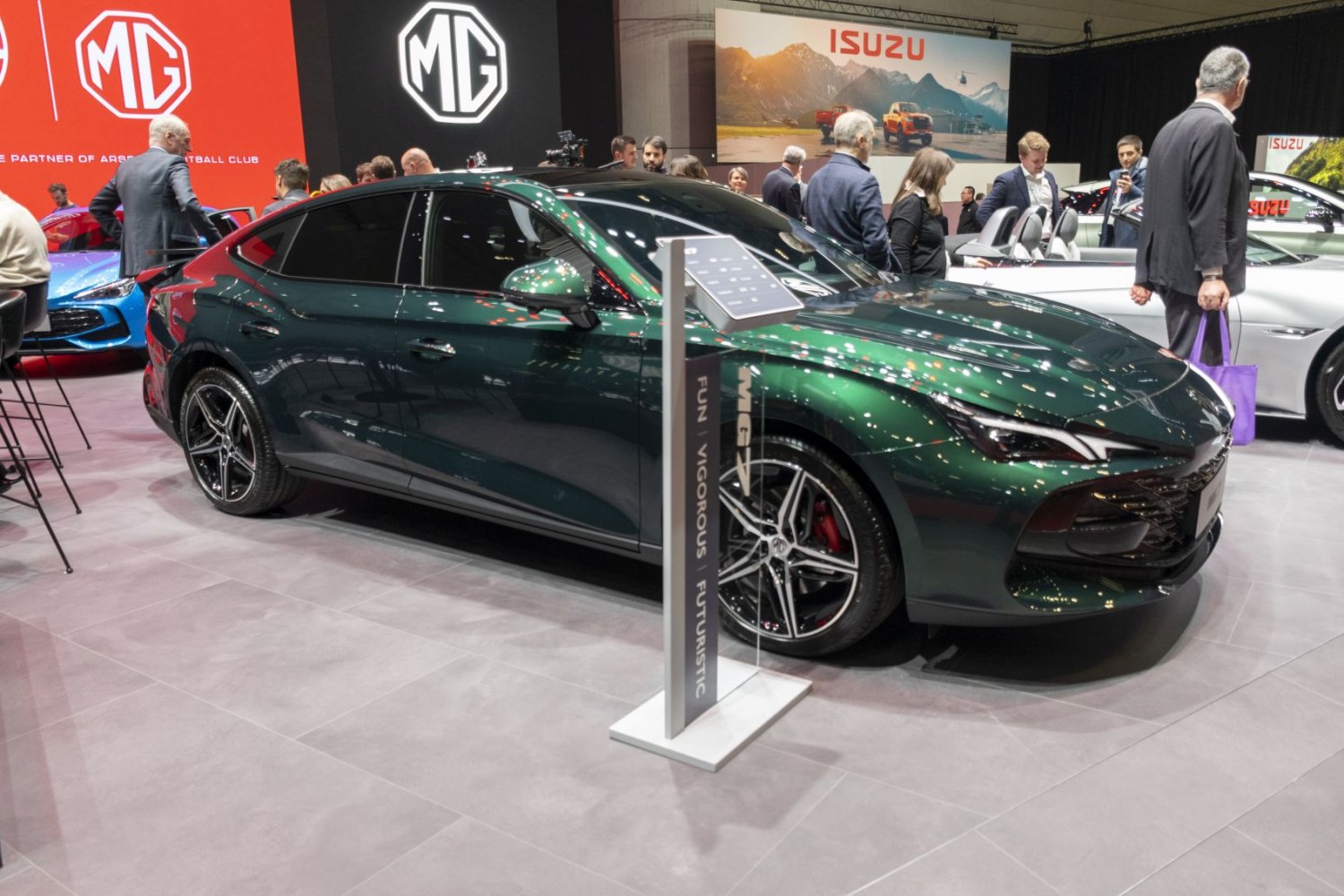 Sporty green sedan with aerodynamic curves and multi-spoke alloy wheels