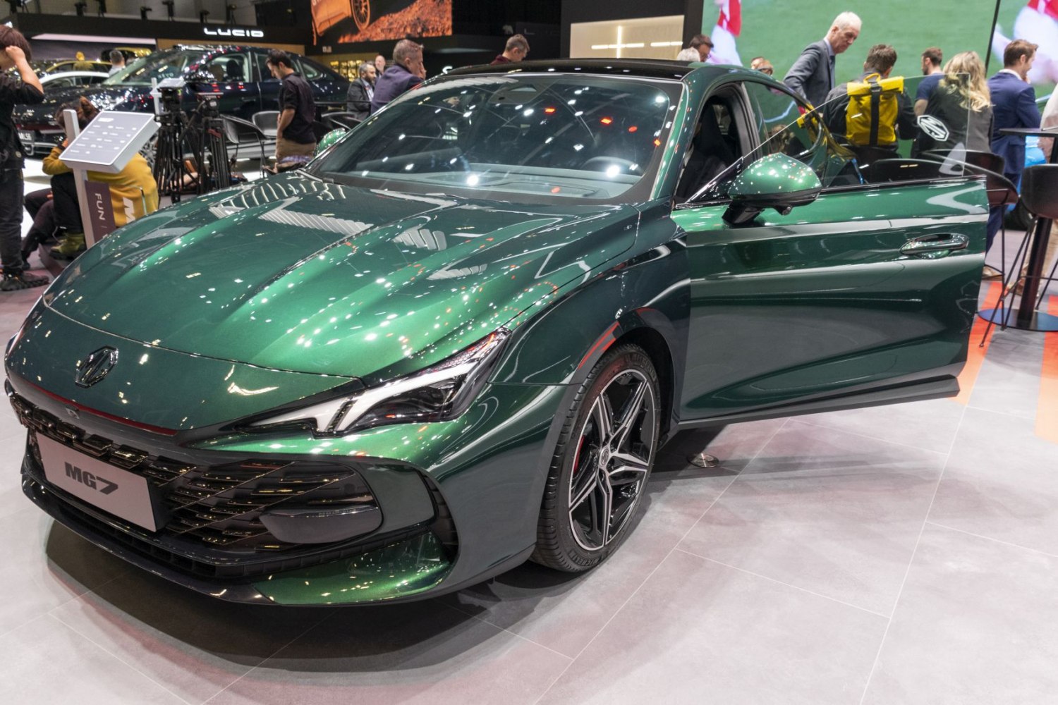 Sporty green sedan with LED headlights and open front door