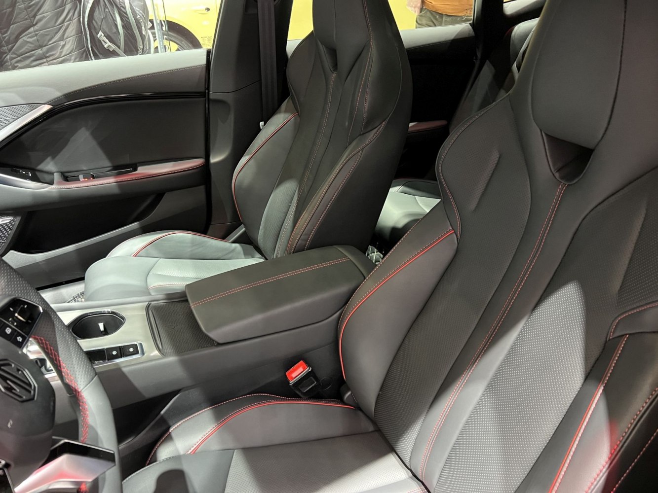 Leather front seats with red stitching and center console