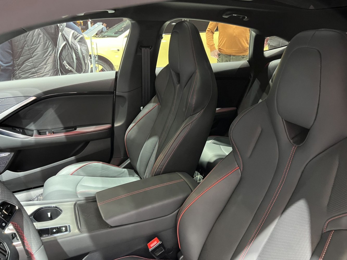 Sporty front seats with red stitching and center console close-up