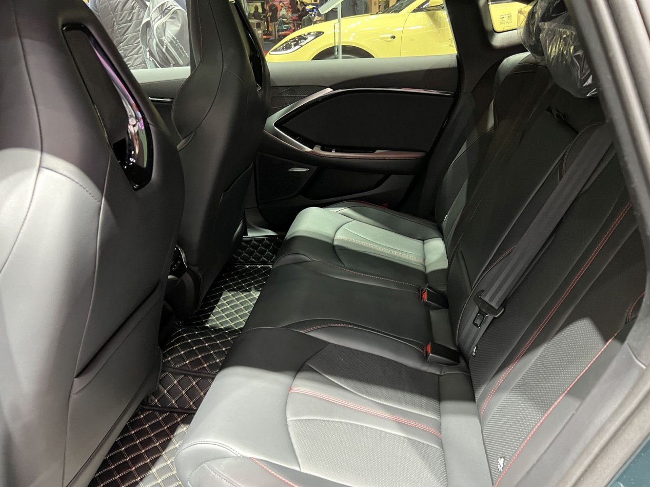Rear seats with black leather upholstery and red stitching