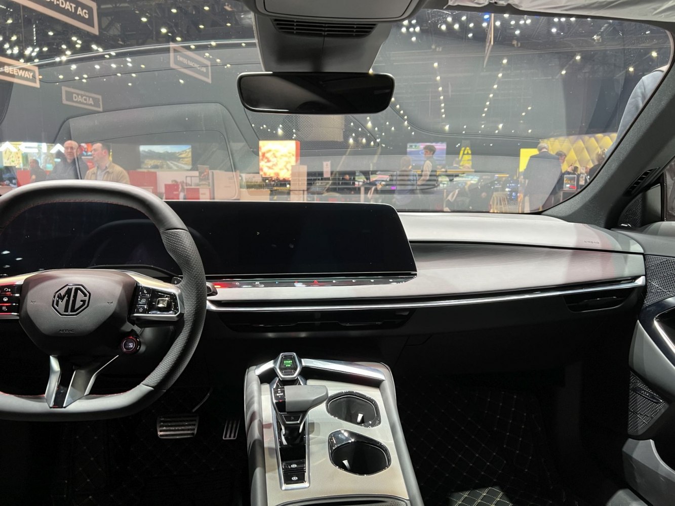 Wide digital dashboard display and futuristic gear selector in modern car interior